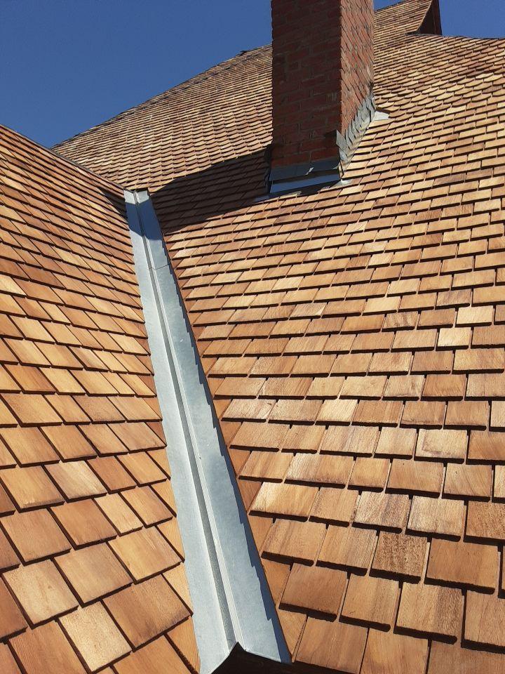 Custom metal valley and chimney flashing on the Western red cedar roof of the Sullivan House in Dallas.
