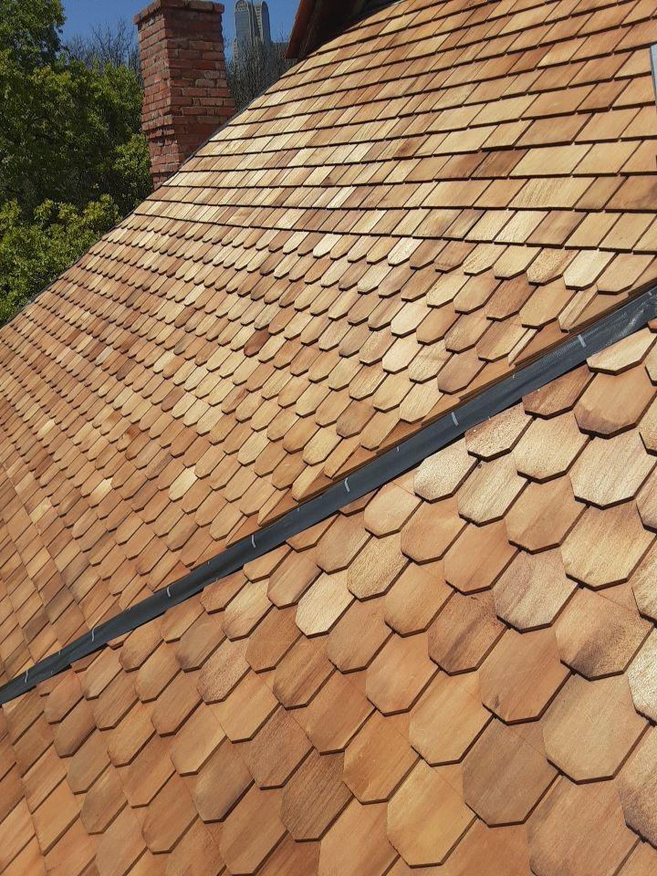 Hand-cut scalloped and diamond-shaped cedar shingles on the historic Sullivan House roof in Dallas.