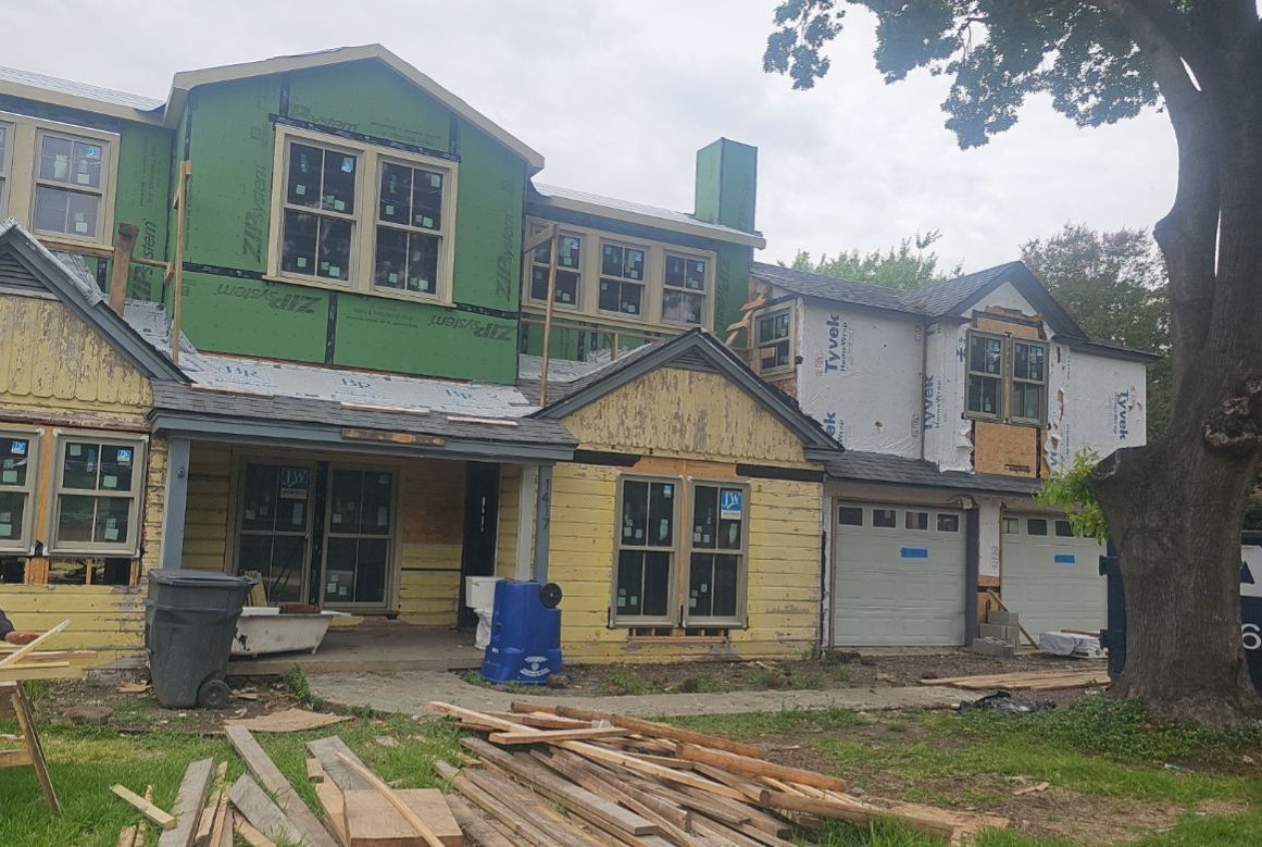 New construction home in Casa Linda Estates during the roof dry-in stage before shingle installation.