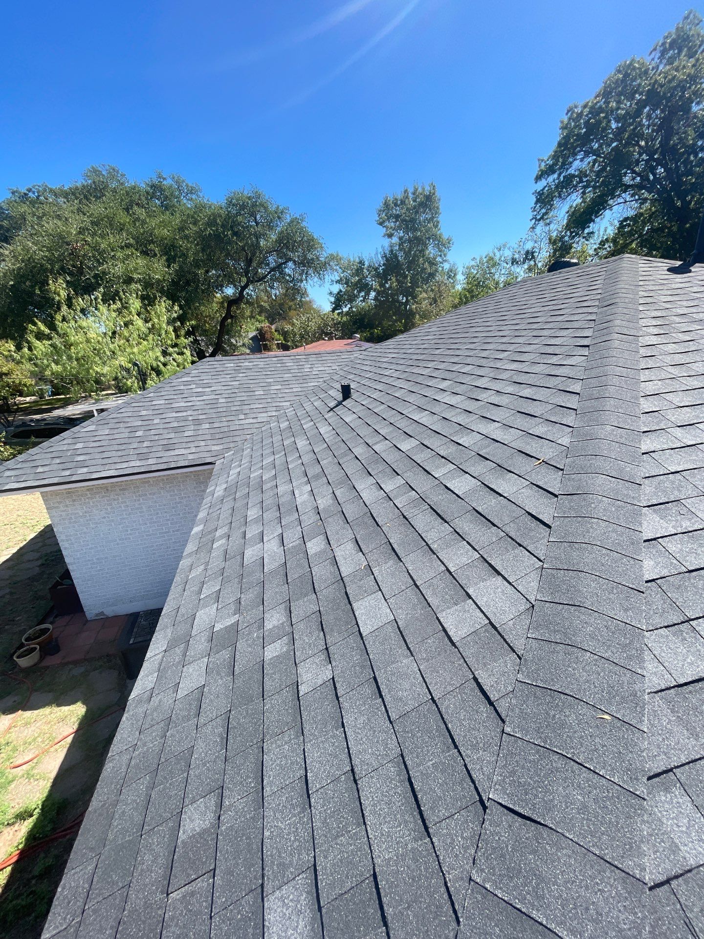 Completed Owens Corning Duration STORM roof in Onyx Black with turbine ventilation in Casa View, Dallas 75228.