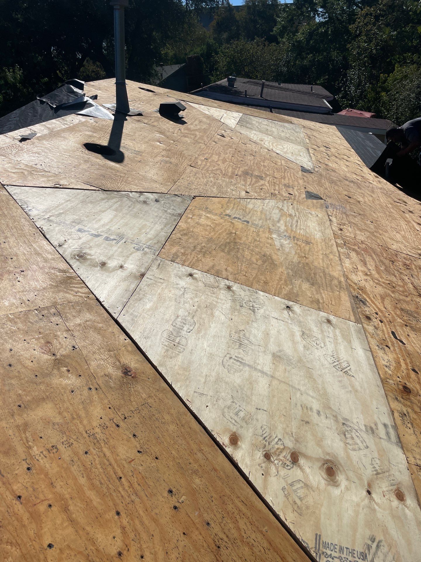 Plywood roof decking repairs following removal of outdated ventilation dormers on a Casa View home in Dallas.