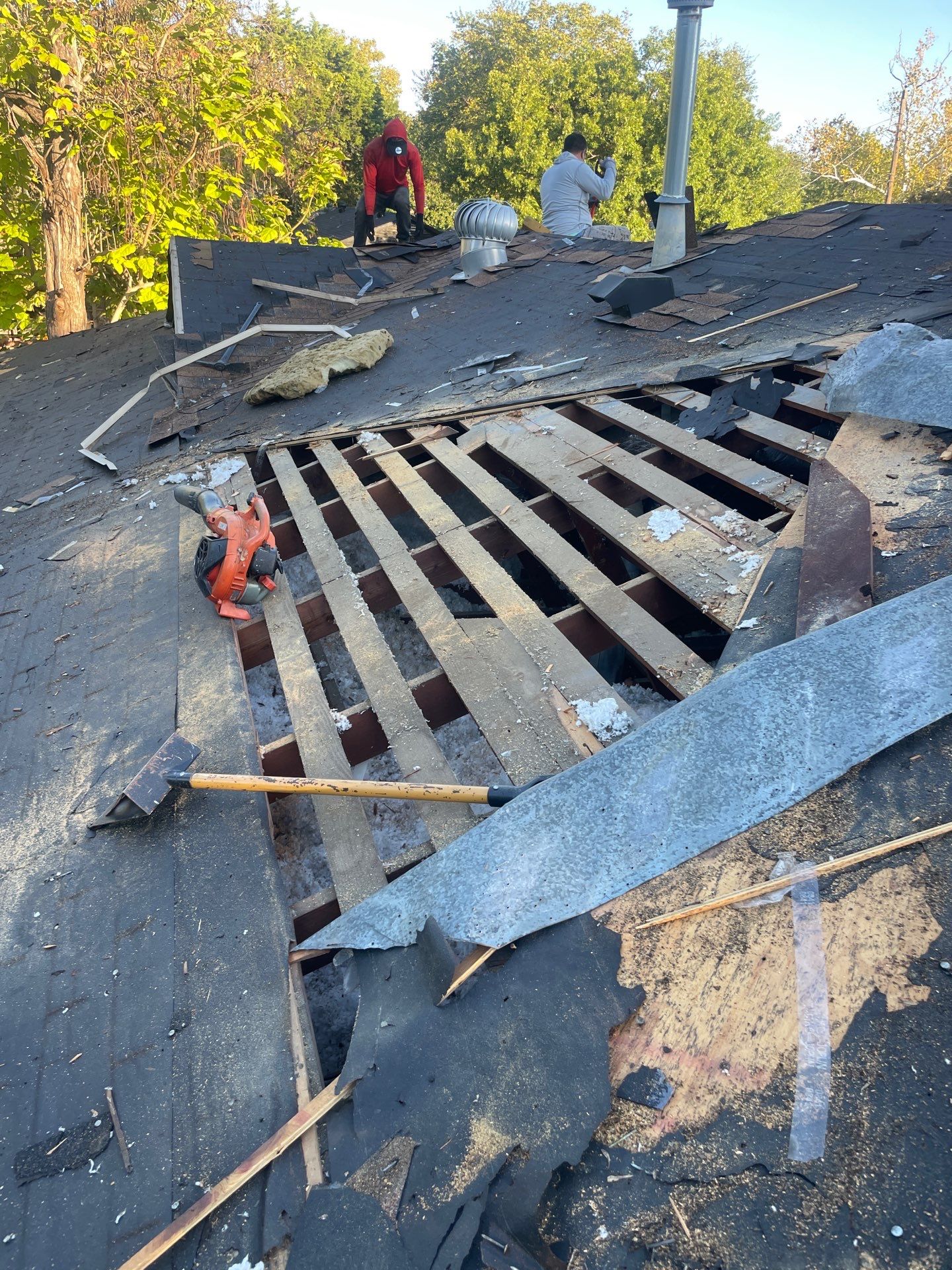 Exposed roof framing and decking opening after removal of an outdated ventilation dormer in Dallas 75228.