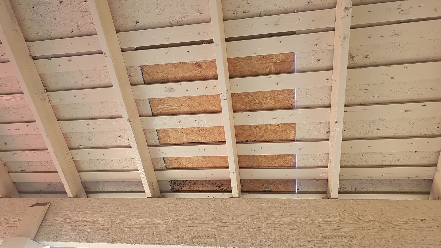 Open-air garage ceiling after replacement of damaged roof decking on a Far North Dallas home in 75248.