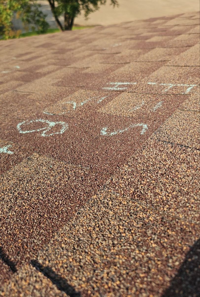 Garland TX roof inspection showing chalk circles from a prior hail inspection
