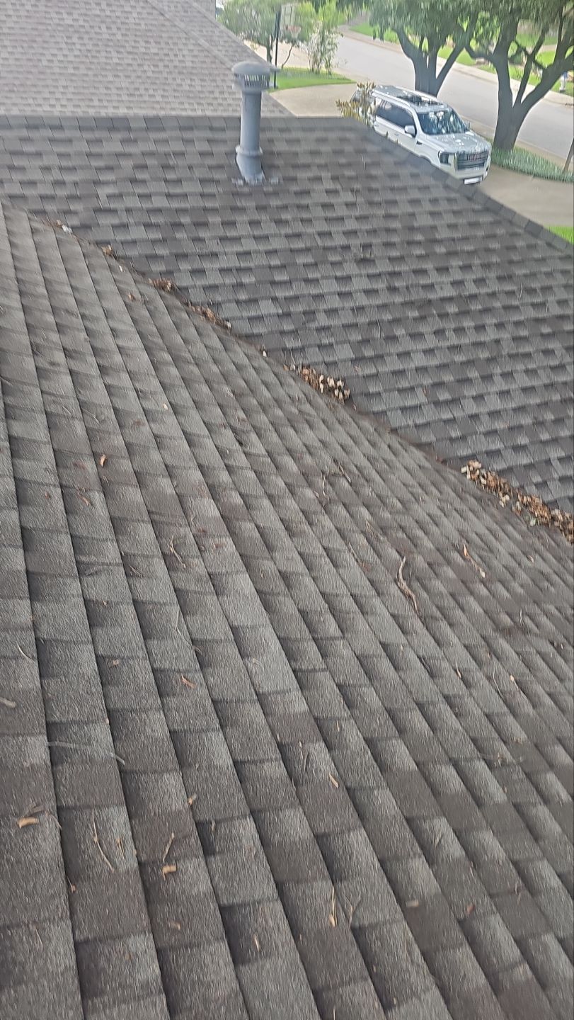 Acorns and debris collecting in a roof valley in Lake Highlands, Dallas 75231