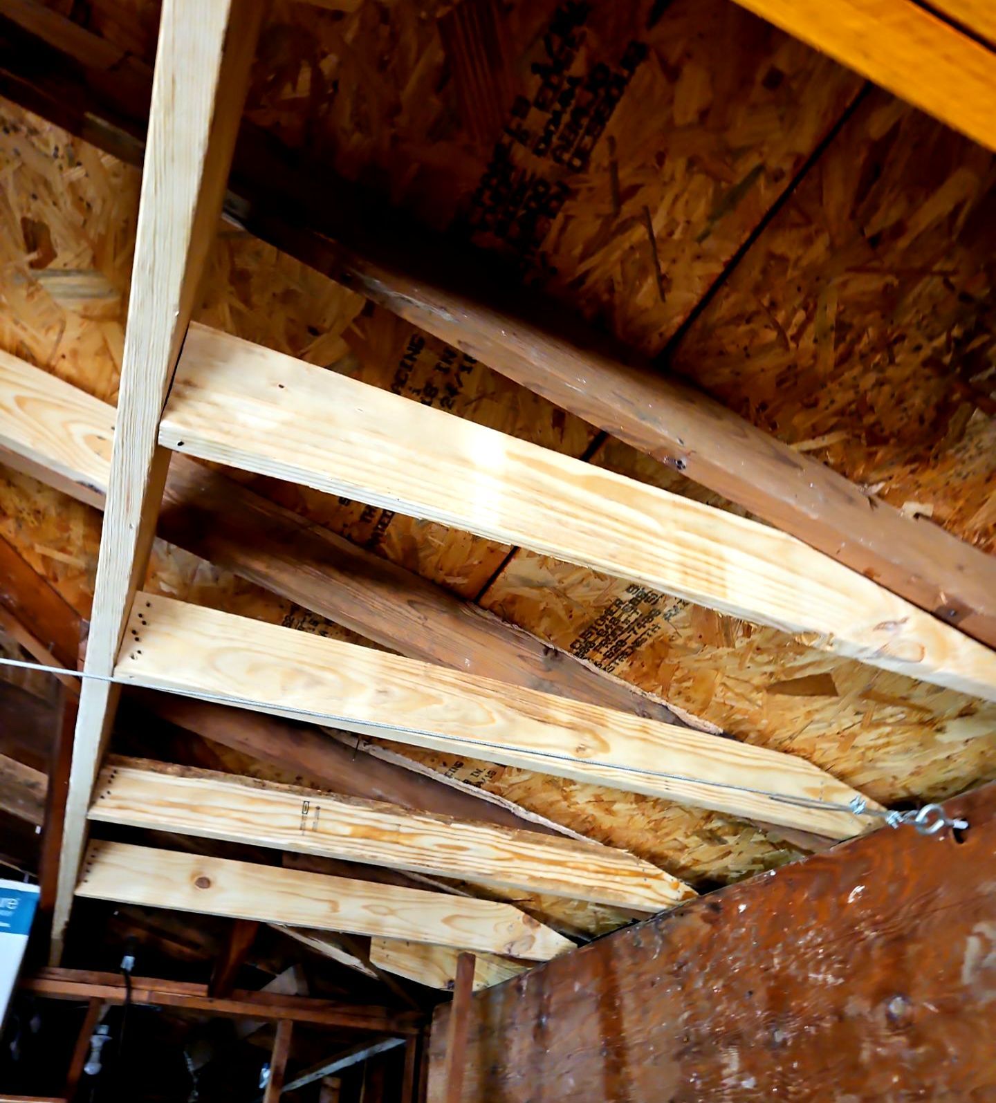 Exposed roof framing and decking repairs on a detached garage in East Dallas 75218