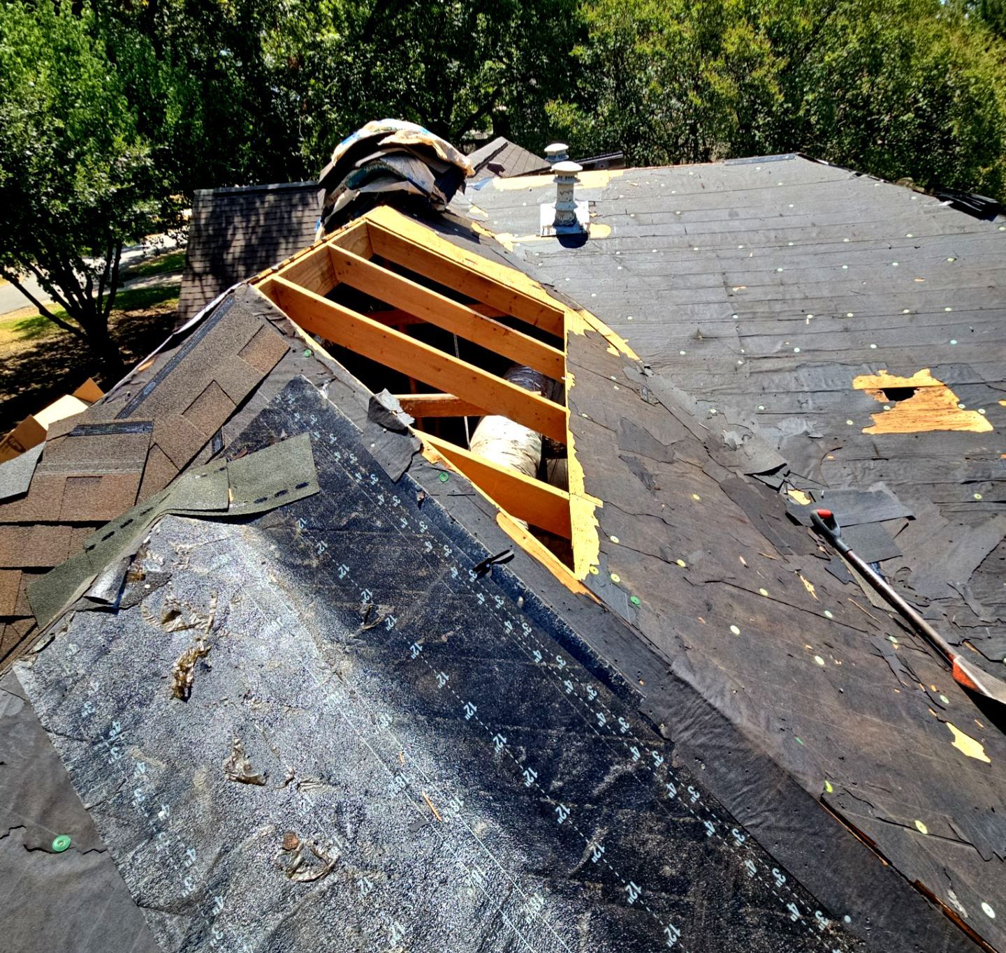 Roof tear-off exposing complex roof geometry during replacement in East Dallas 75218