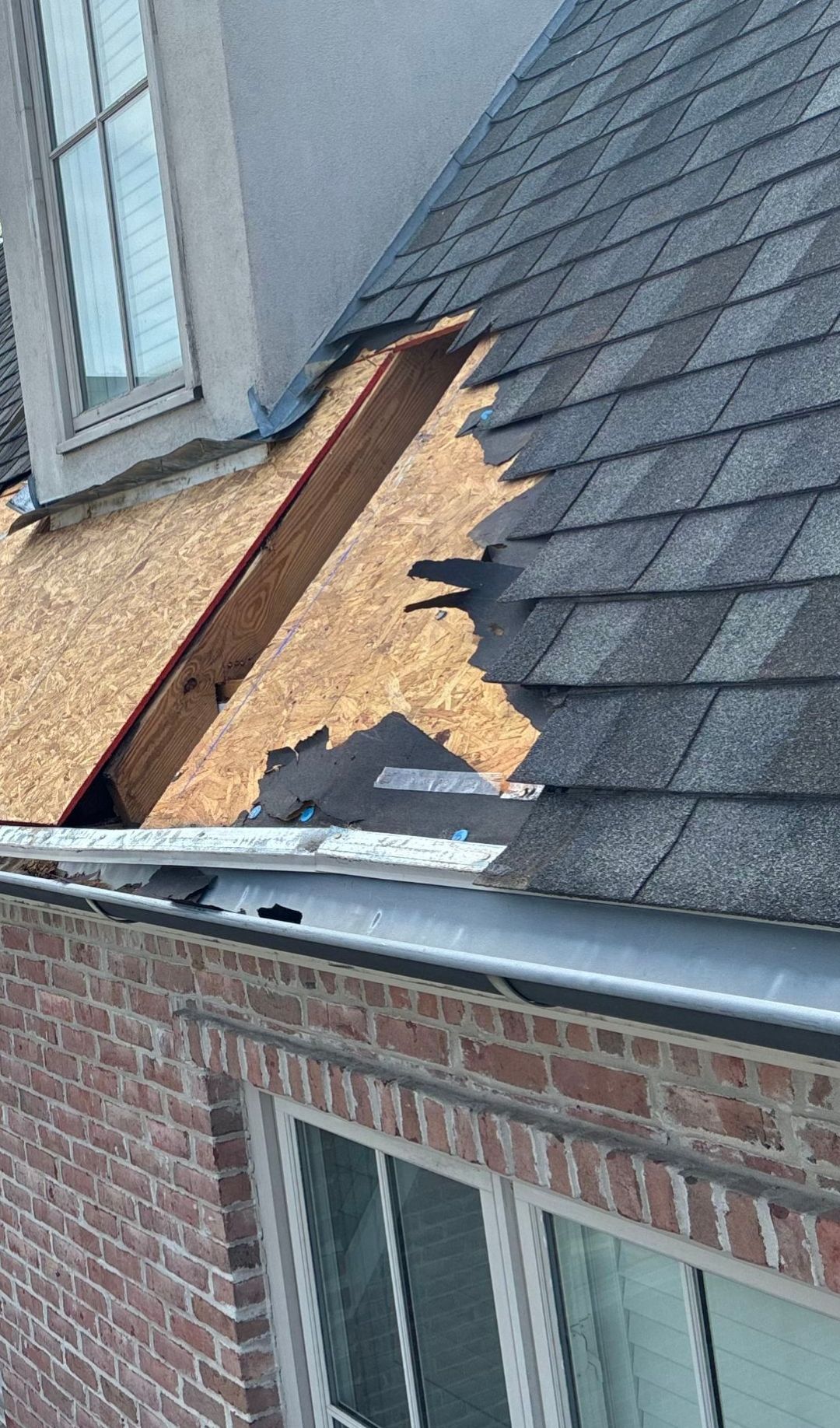 Exposed roof decking and damaged shingles during raccoon roof repair in University Park Dallas 75225