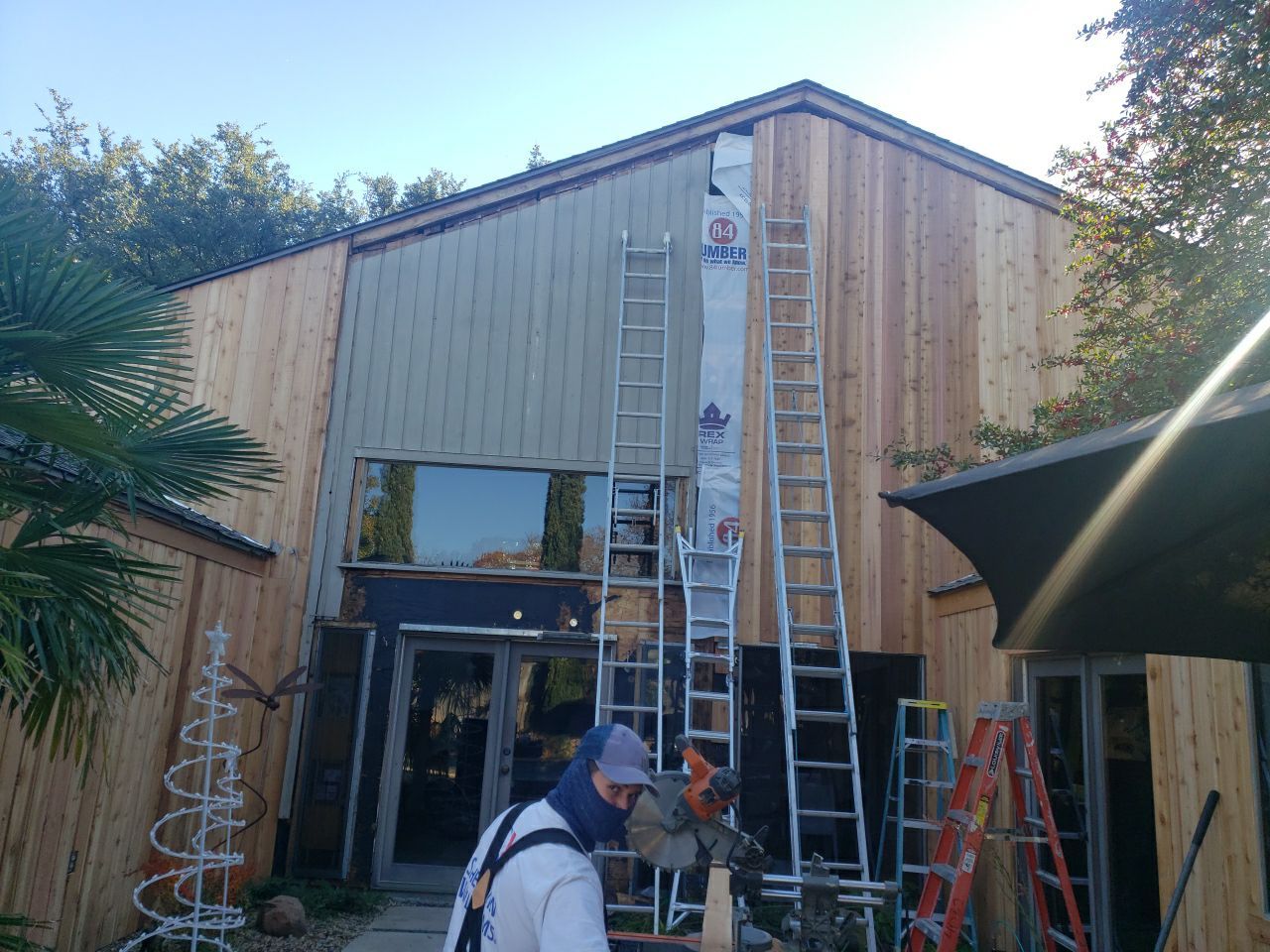 Cedar siding and house wrap installation in progress on a Lake Highlands home in Dallas 75231.