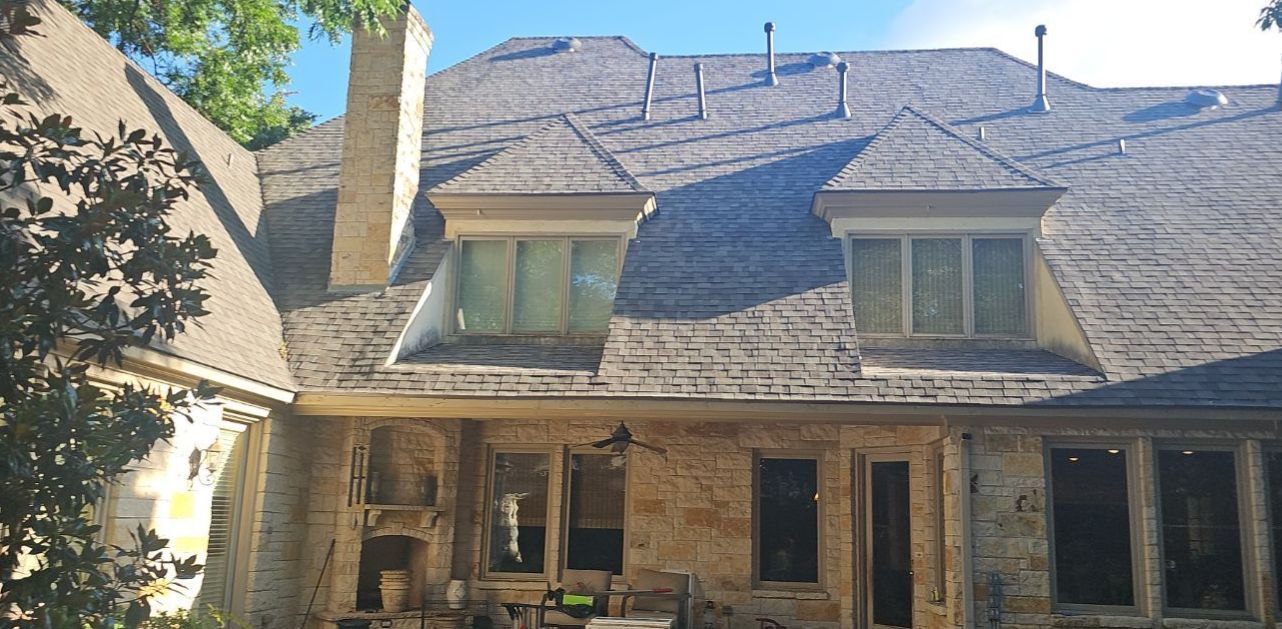 Rear view of a steep, complex Preston Hollow home with a new Owens Corning Duration Class 3 roof.