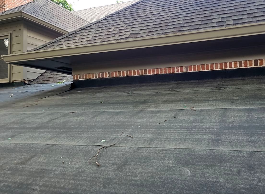 Ice and water shield covering a low-slope roof addition tied into an existing Preston Hollow roof in Dallas 75225