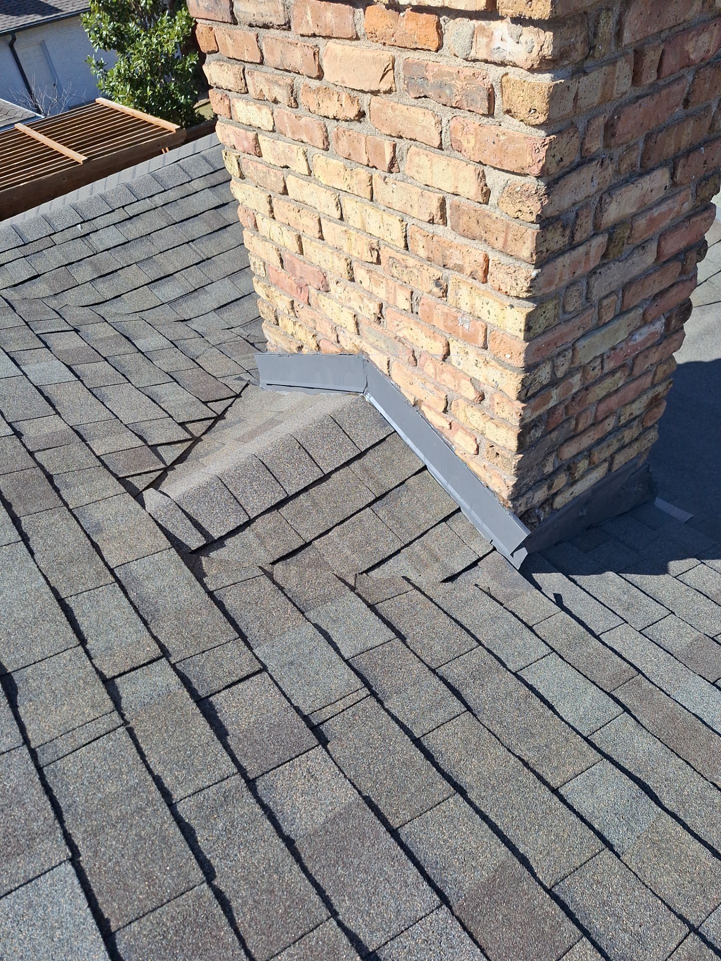 New chimney flashing detail on a Class 4 roof replacement in Dallas 75214