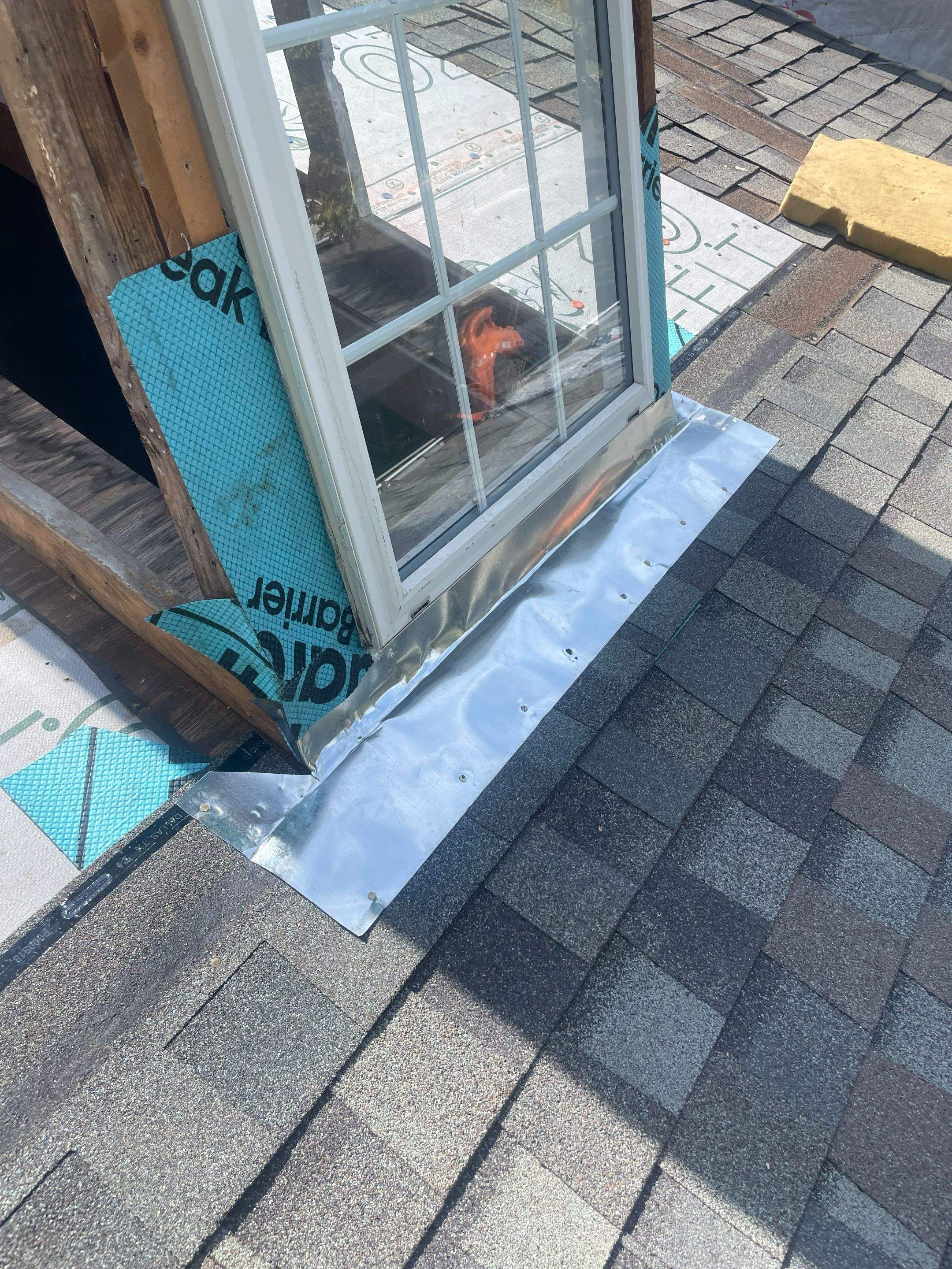 Metal flashing and shingle repair at a dormer roof-to-wall intersection on a Highland Park home near SMU.