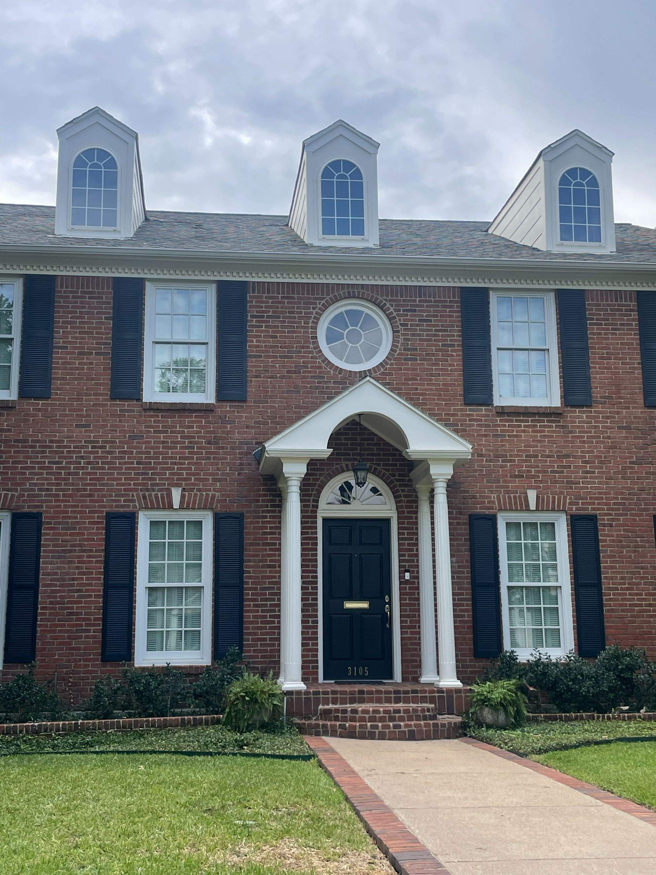 Three repaired dormers on a brick Highland Park home near SMU, with new Hardie siding, flashing and matching TAMKO shingles.