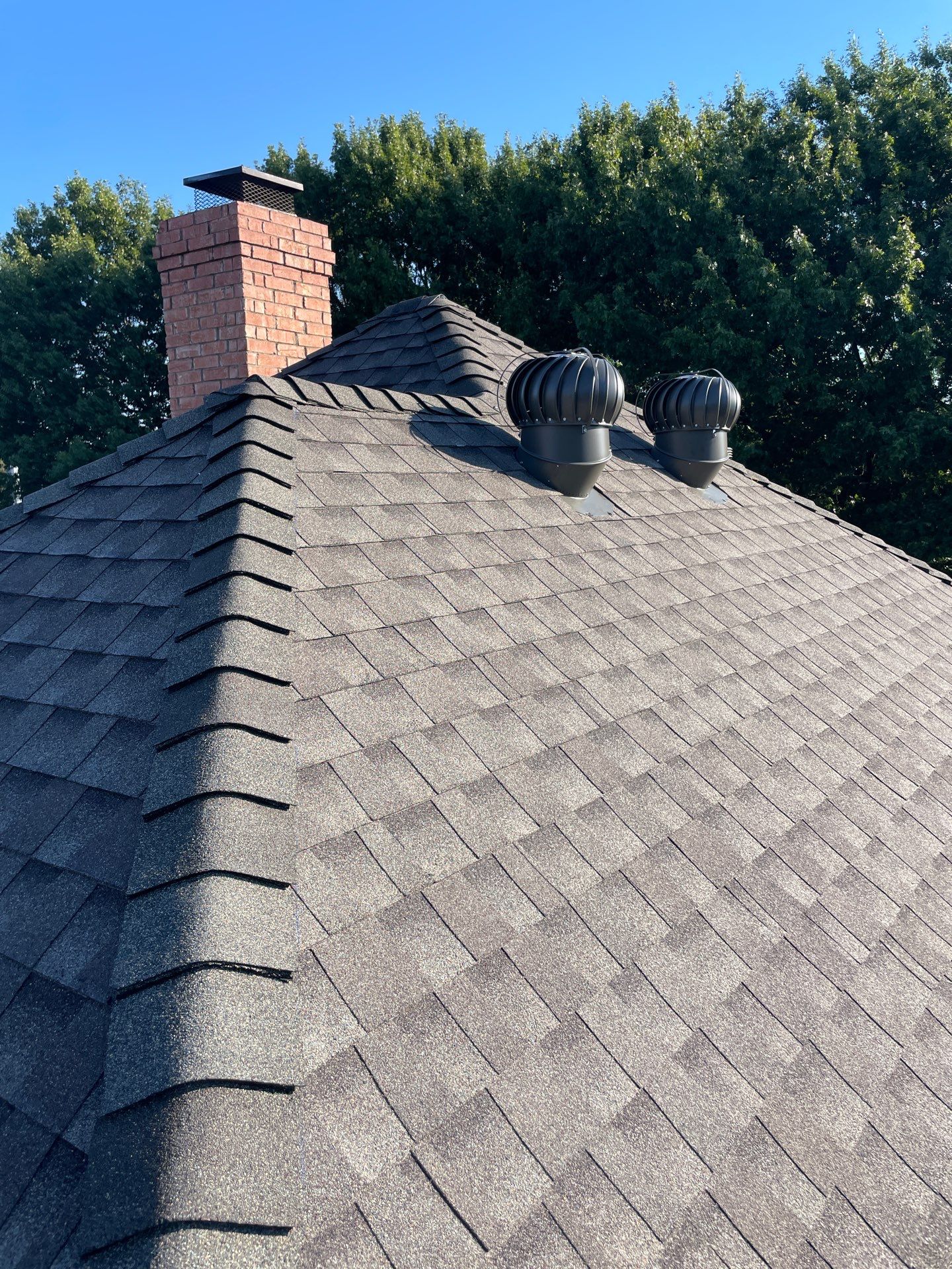 GAF Z-Ridge enhanced-profile hip shingles installed with Timberline HDZ Weathered Wood shingles on a roof in Firewheel, Garland, TX.