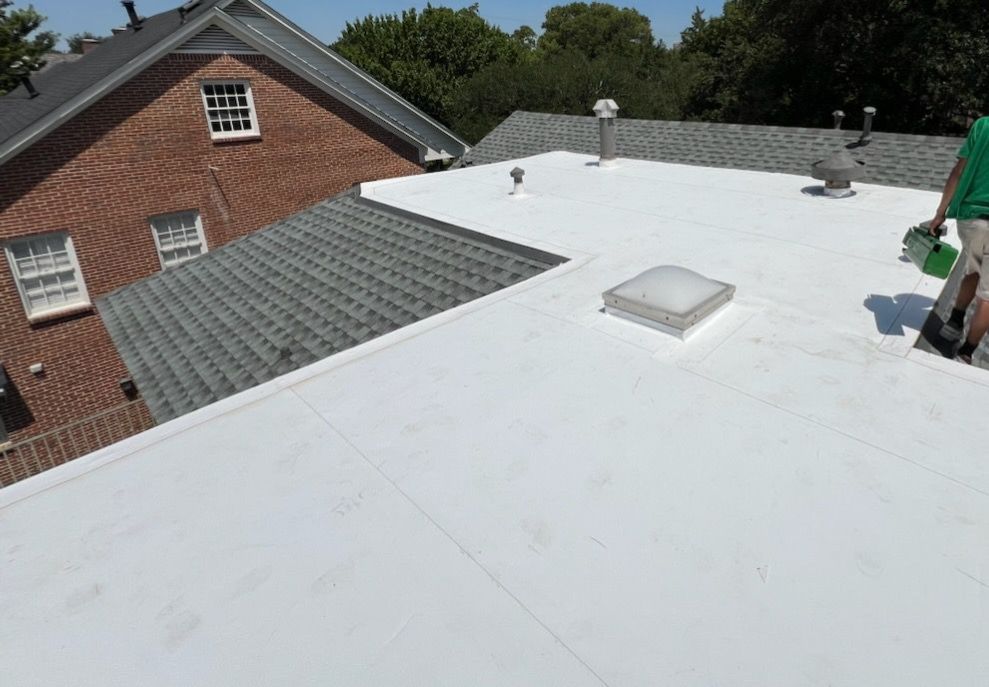 White TPO membrane beside asphalt shingle roof sections on a low-slope roofing project in University Park.